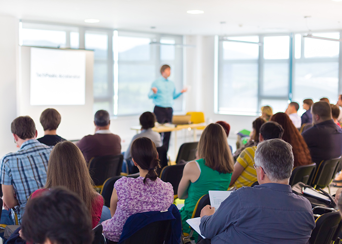 Presenter giving speech to attendants 