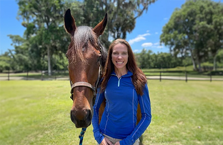 Andi Davison stands with a horse