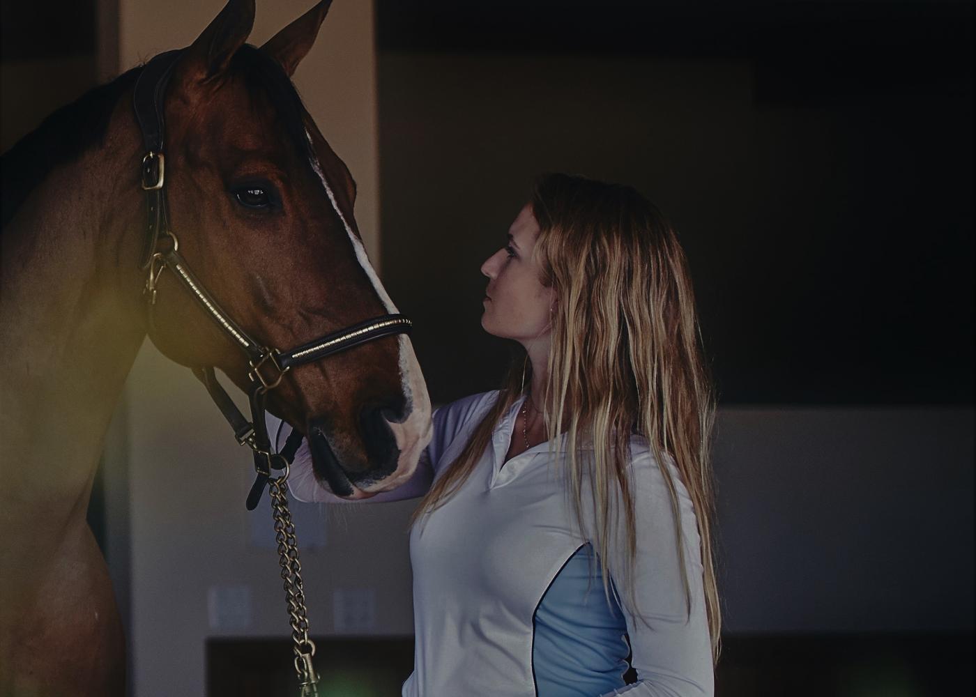 Horse owner starring at horse