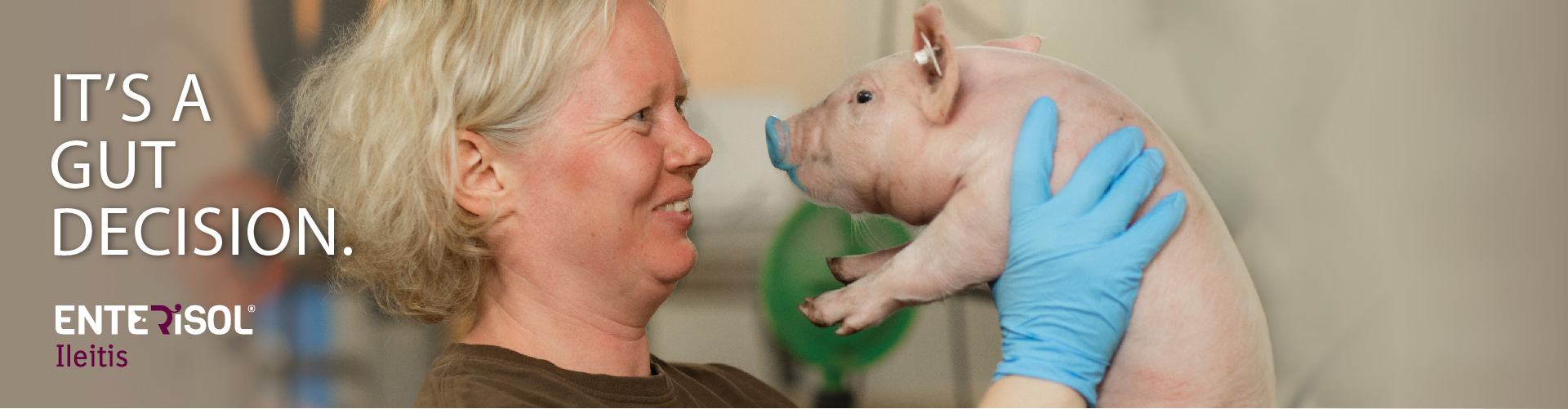 Enterisol Ileitis 'It's a Gut Decision' image with woman holding piglet